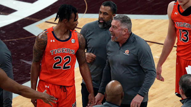Mar 2, 2022; Starkville, Mississippi, USA; Auburn Tigers head coach Bruce Pearl (right) talks with guard Allen Flanigan (22) during the first half again the Mississippi State Bulldogs at Humphrey Coliseum. Mandatory Credit: Petre Thomas-USA TODAY Sports